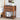 Wooden nightstand with books and a vase in a bedroom setting