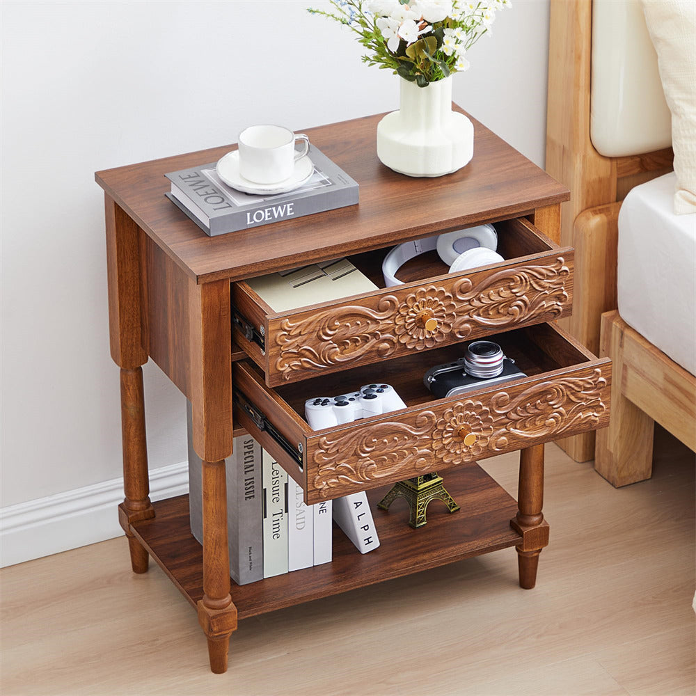 Wooden side table with decorative carvings, books, and a vase on a light wood floor.