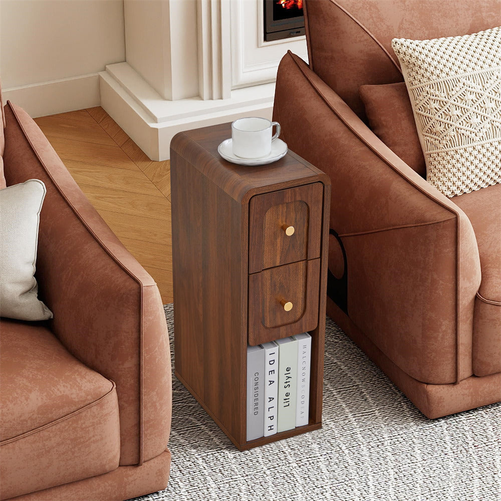 Wooden side table with two drawers next to a brown sofa in a living room setting.