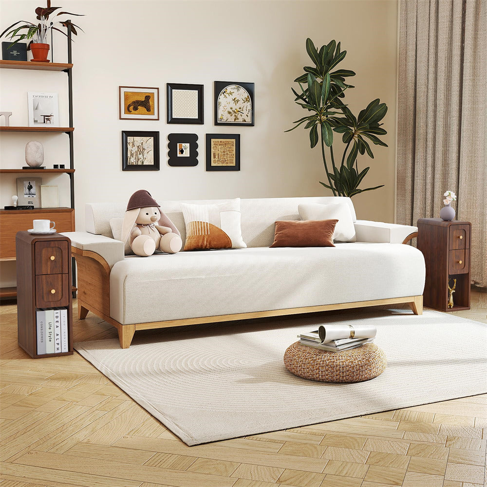 A modern wooden daybed with a white upholstered seat, styled in a warm, contemporary living room with a white rug, wooden floor, and wall art.