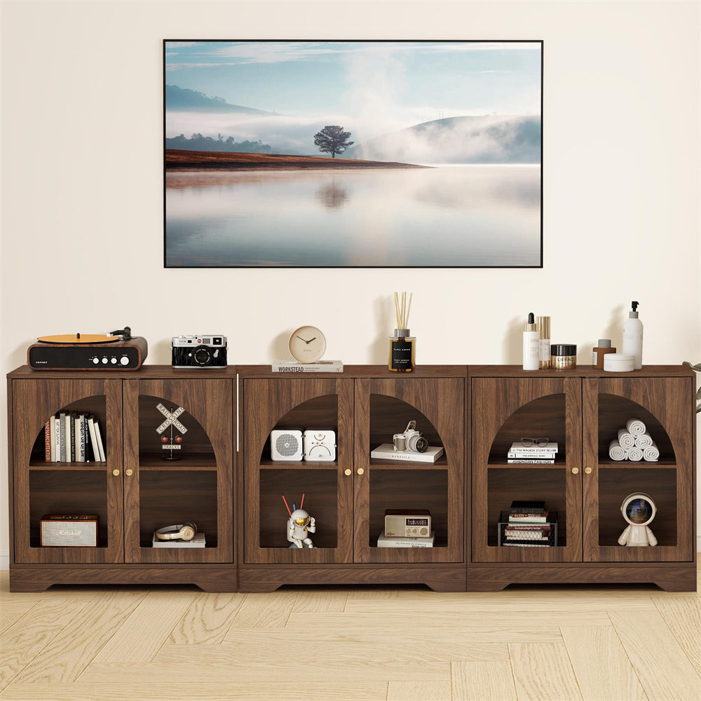 Wooden entertainment console with decorative items against a wall with a TV displaying a nature scene.