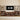 Wooden entertainment center with shelves and a digital clock on the wall.