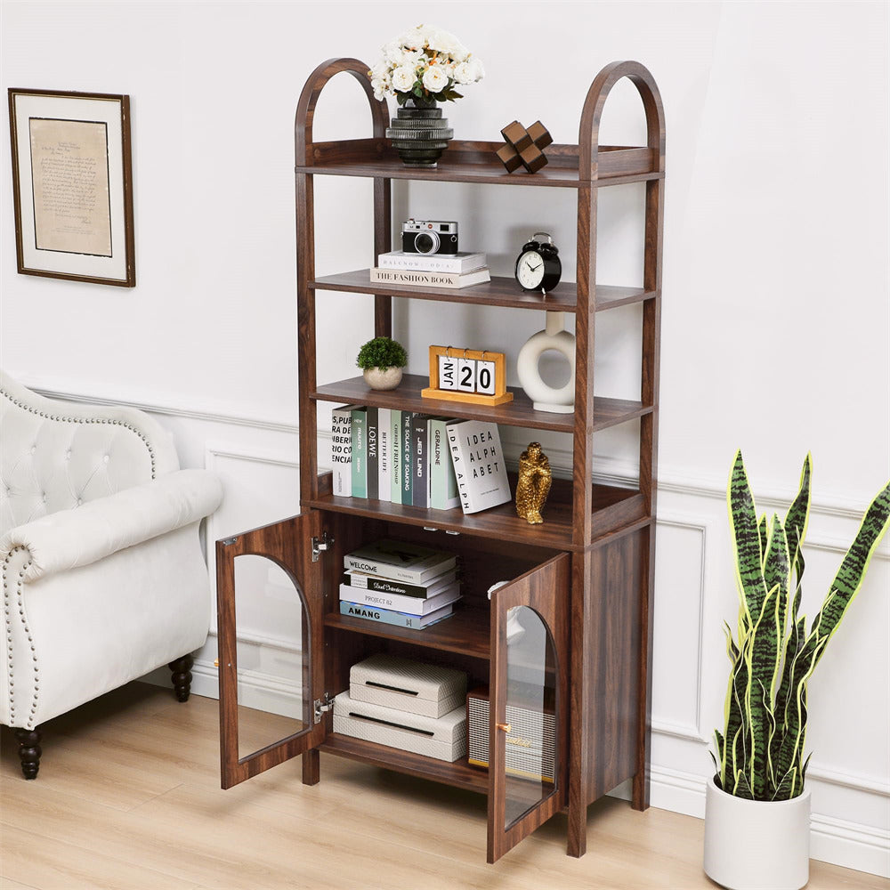 Wooden bookshelf with glass doors in a room with a white sofa and plant.