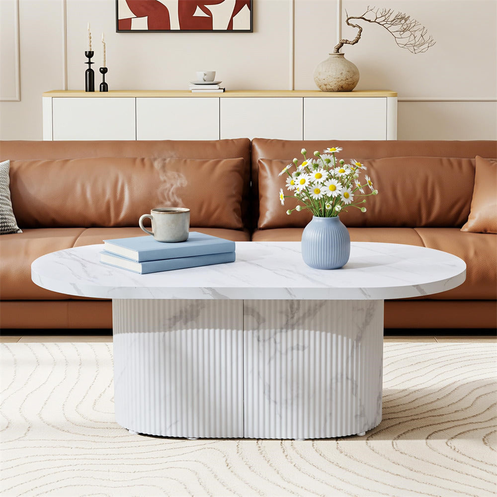 Modern living room with a brown sofa, white coffee table, and decorative items.