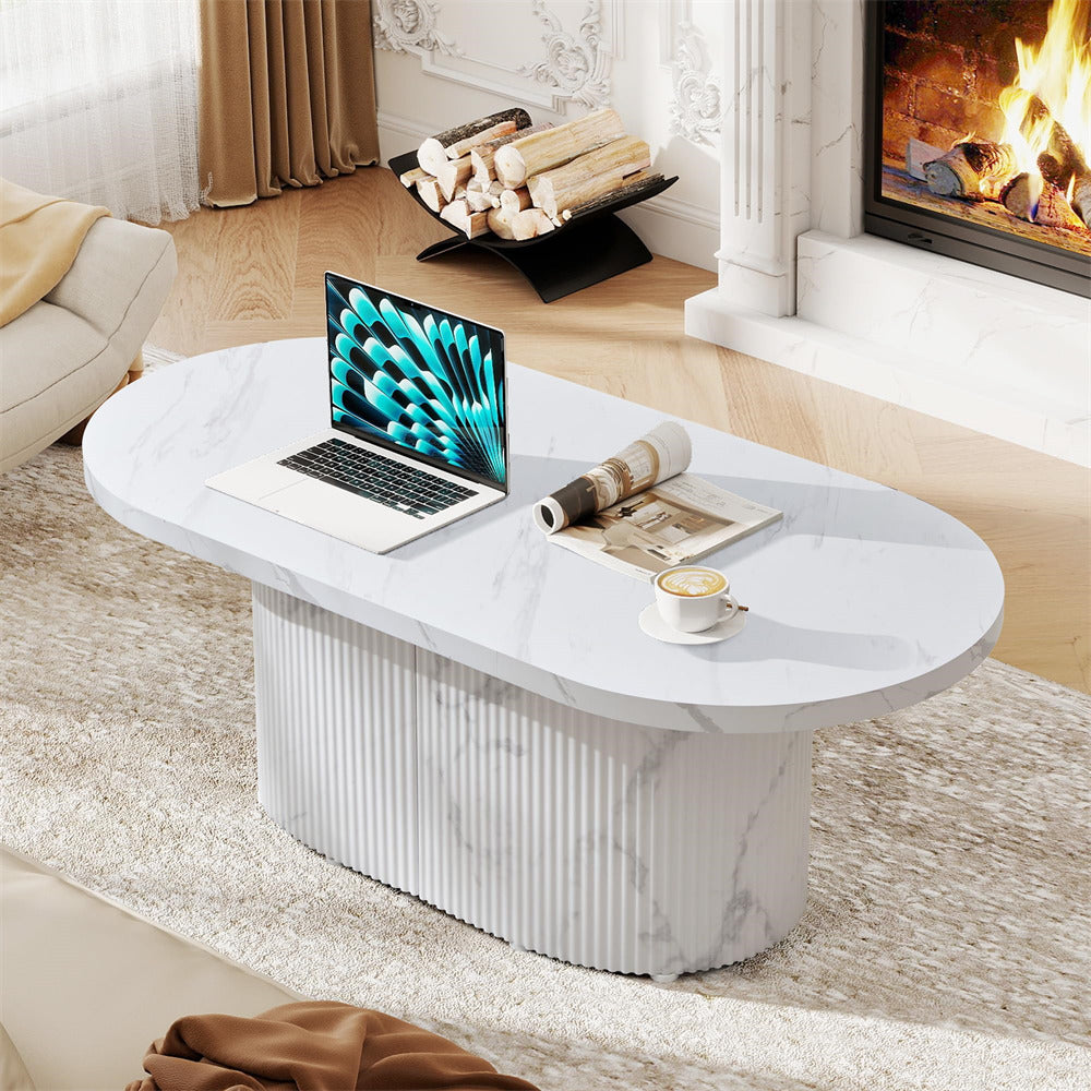 White marble coffee table with a laptop, newspaper, and cup in a living room setting.