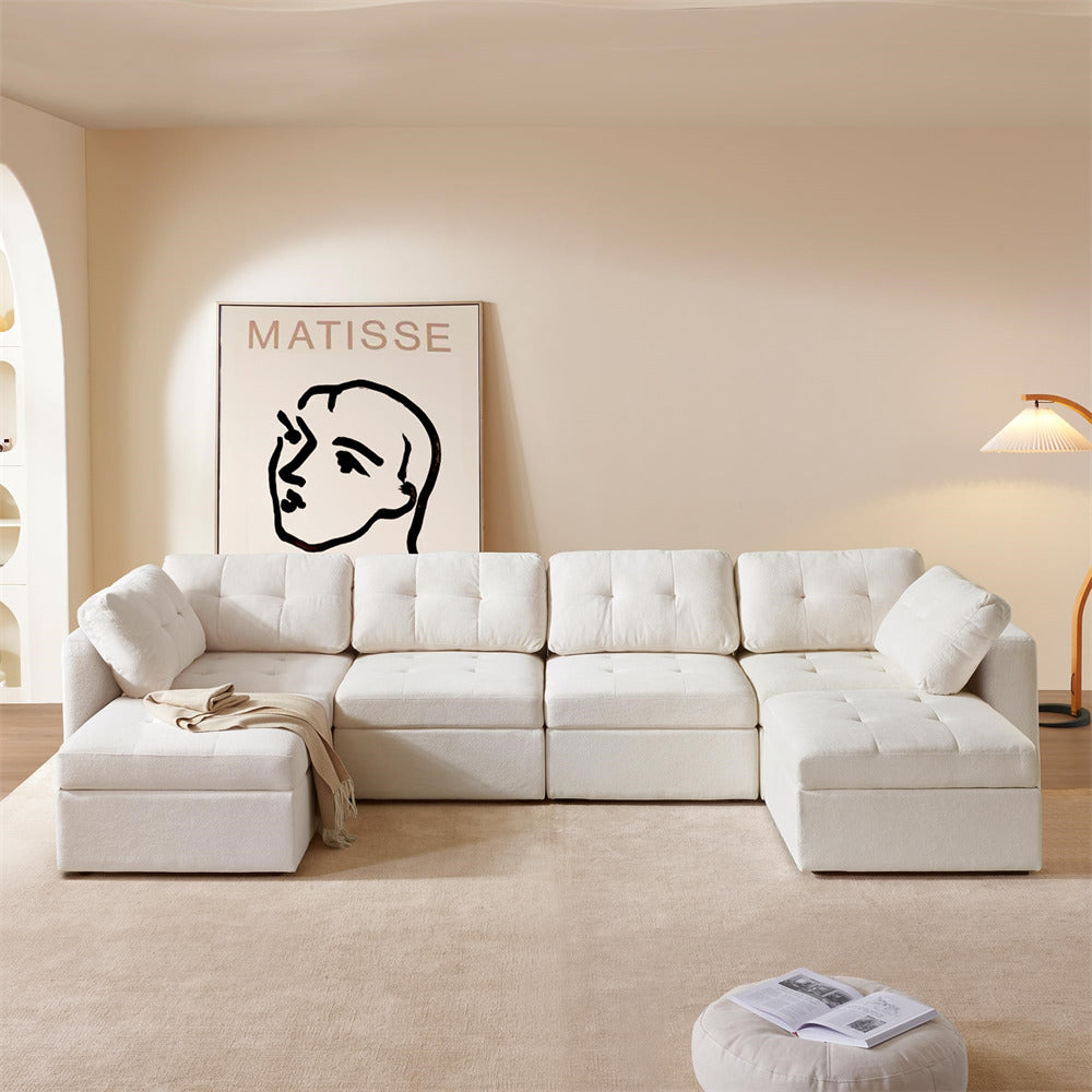 White sectional sofa in a living room with a Matisse painting on the wall.