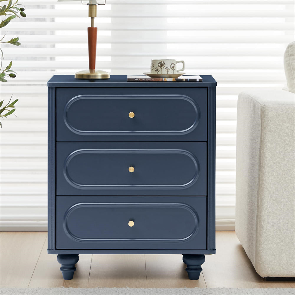 Navy blue three-drawer nightstand with gold knobs in a room setting.