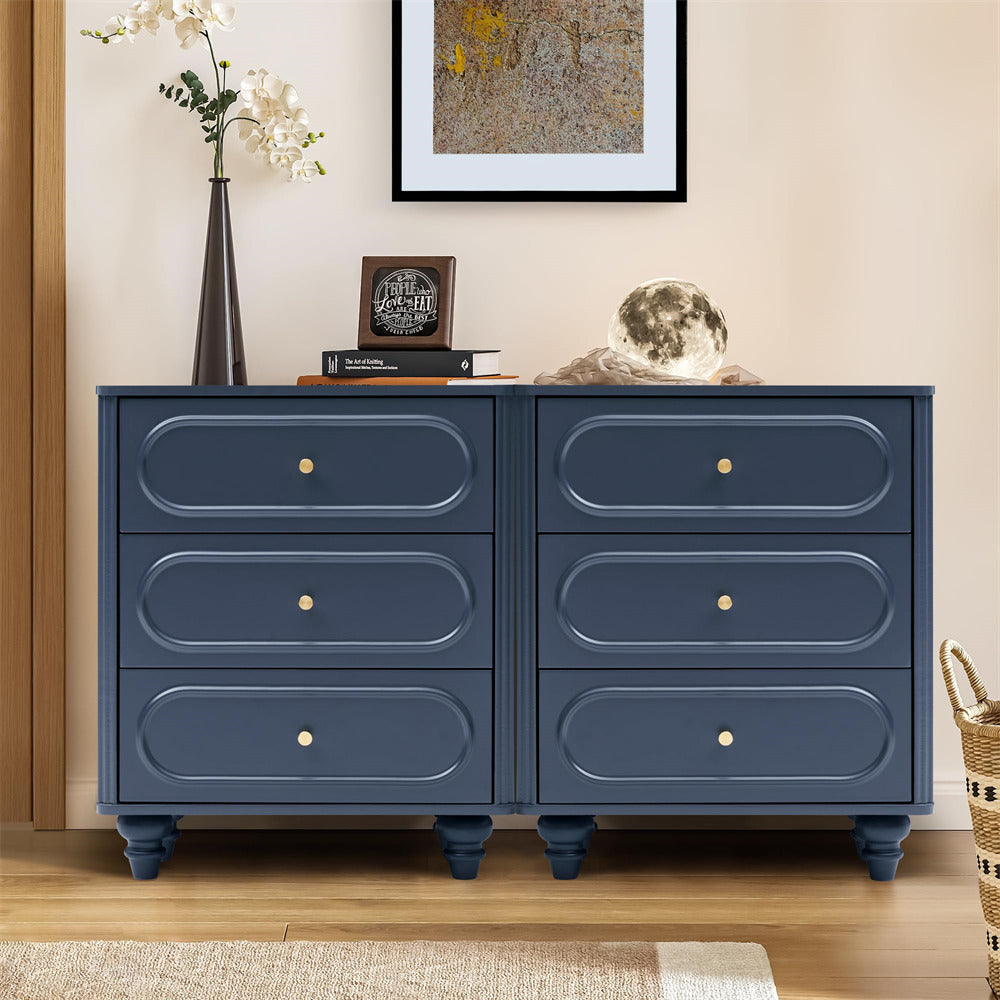 Blue dresser with four drawers in a room setting with decor items.