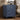 Blue nightstand with three drawers in a bedroom setting